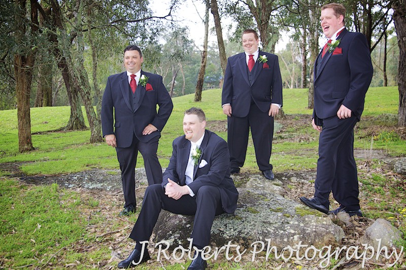 Groom laughing with groomsmen on a golf course - wedding photography sydney